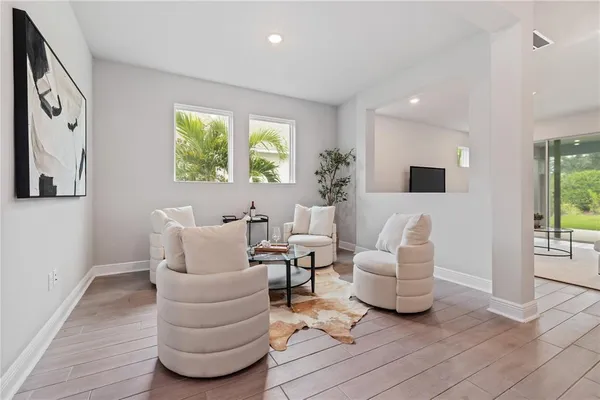 a living room with furniture and a large window