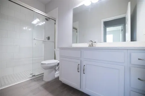 a bathroom with a toilet sink and shower