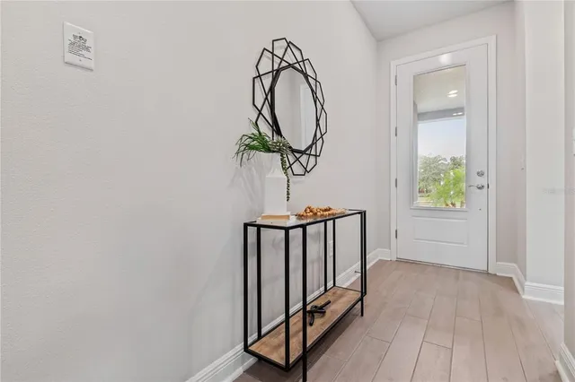 a view of a hallway with wooden floor and entryway