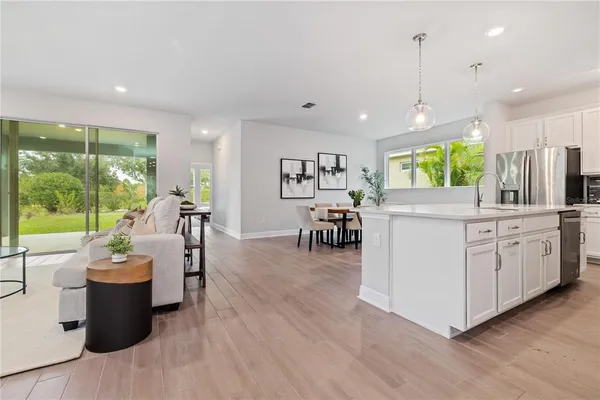 a very nice looking living room with a large window and stainless steel appliances