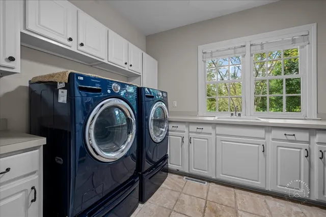 a utility room with sink dryer and washer
