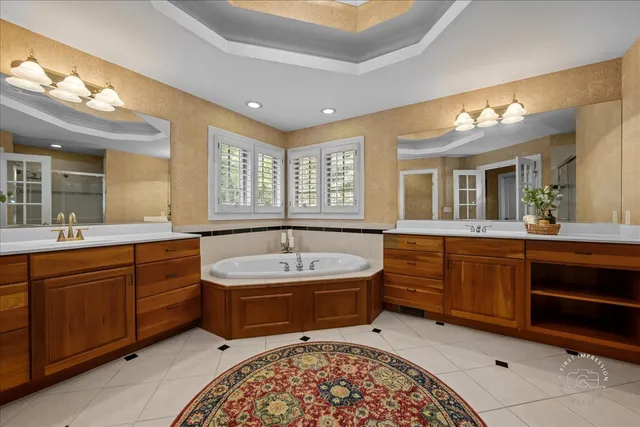 a spacious bathroom with a sink mirror and bathtub