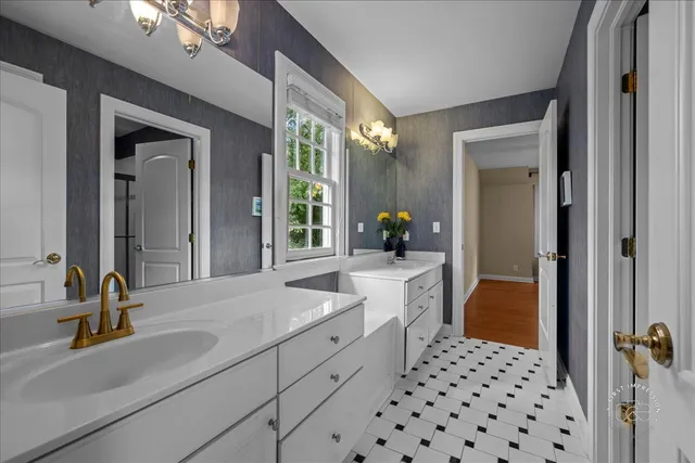 a bathroom with a sink a double vanity and a mirror