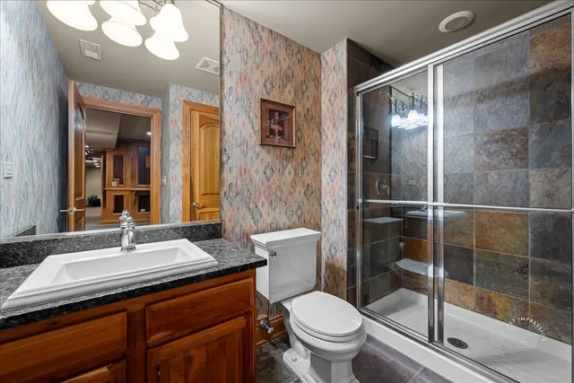 a bathroom with a sink vanity mirror and toilet