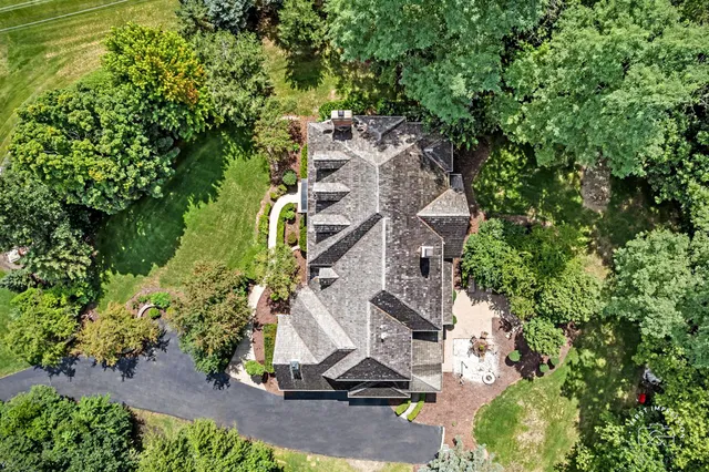 an aerial view of a house with a yard