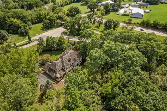 an aerial view of a house with a yard and lake view