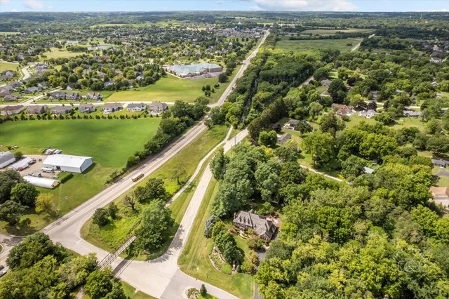 an aerial view of residential houses with outdoor space and river