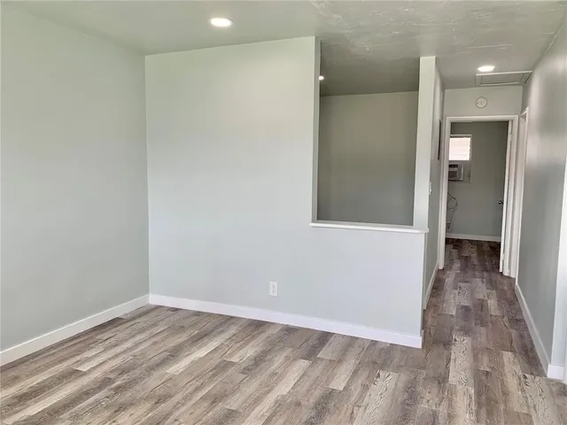 wooden floor in an empty room with a gallery