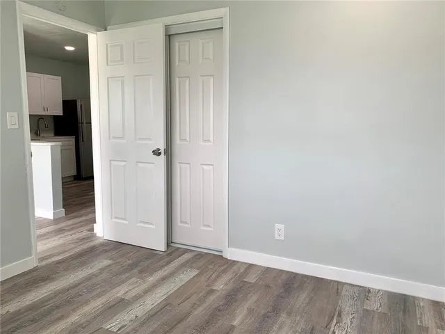 an empty room with closet and a bathroom