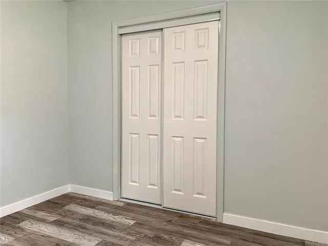 an empty room with wooden floor