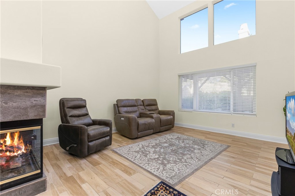 Living room has plenty of natural light and high ceilings