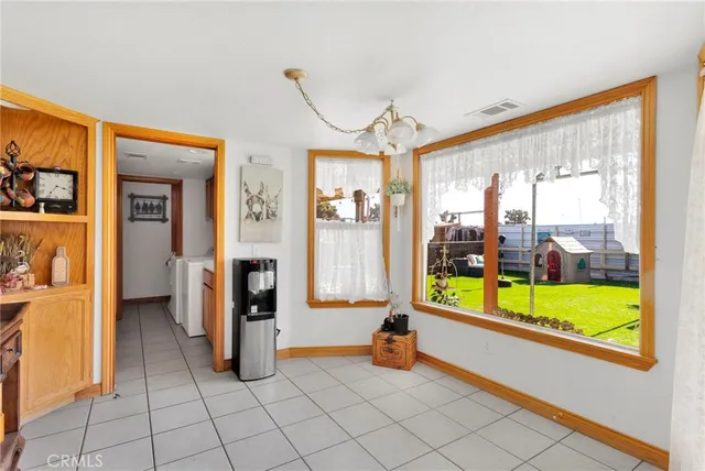 a kitchen with wooden floors and white cabinets