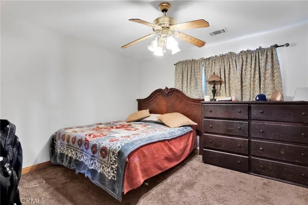 a bedroom with a bed and a view of bedroom