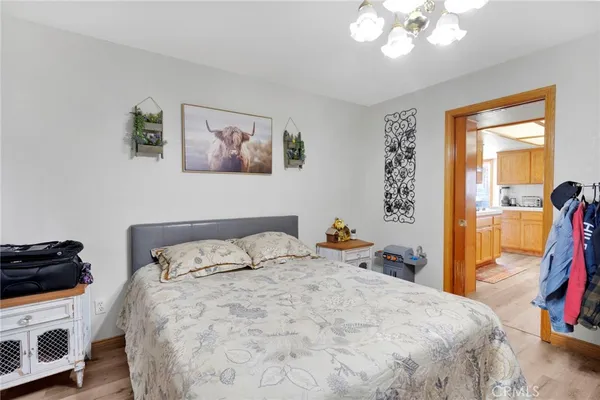 a bedroom with a bed a lamp and a large window