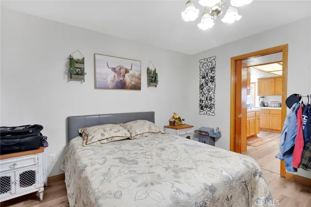 a bedroom with a bed a lamp and a large window