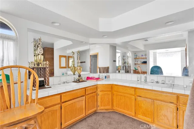 a living room with furniture a large window and wooden floors