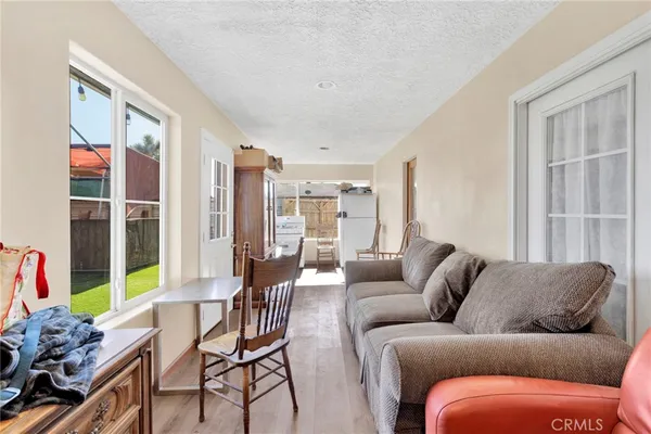 a view of a roof deck with table and chairs and wooden floor
