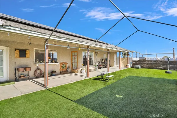 a patio with a yard table and chairs