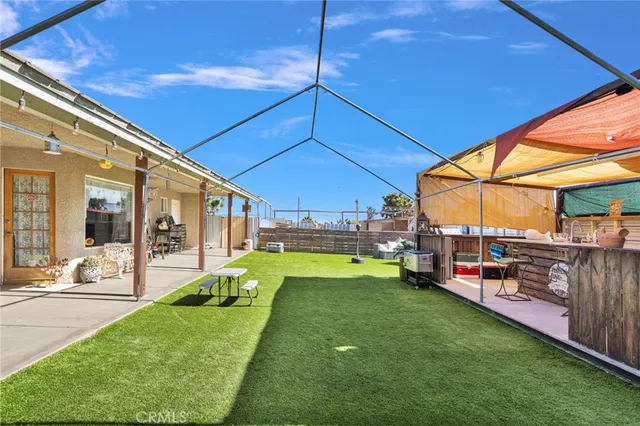a view of a house with a porch and a yard