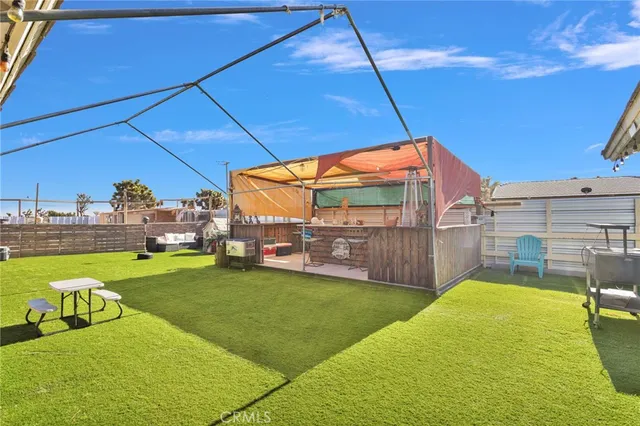 a view of a balcony with two chairs and a floor to ceiling window