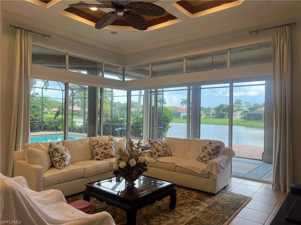8411 Mallow Lane Naples, FL 34113 - Photo 11 of 31 a living room with furniture and a large window
