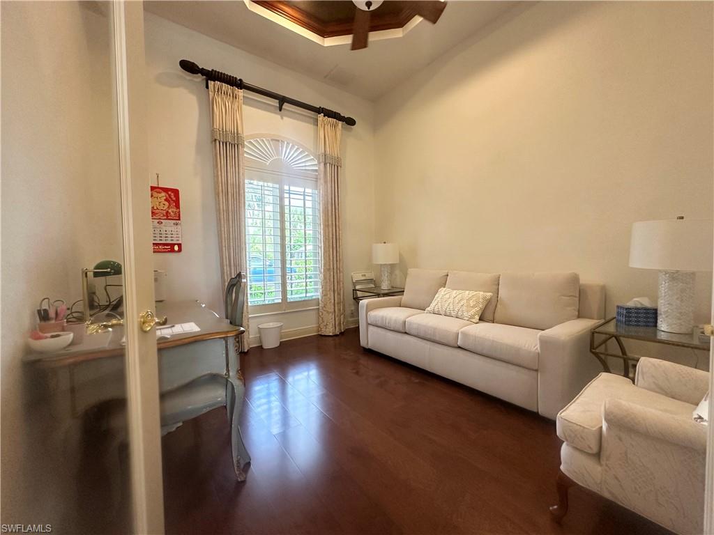 8411 Mallow Lane Naples, FL 34113 - Photo 12 of 31 a living room with furniture and a large window