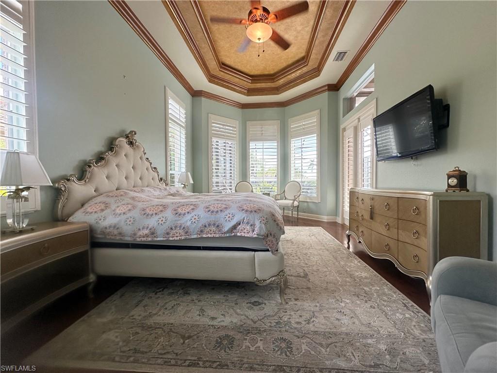 8411 Mallow Lane Naples, FL 34113 - Photo 14 of 31 a spacious bedroom with a bed and a flat screen tv
