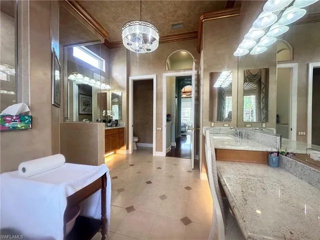 a view of a dining room with furniture a chandelier and wooden floor
