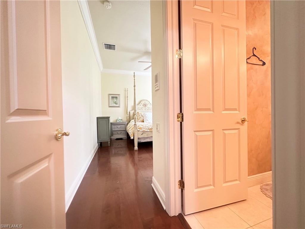 8411 Mallow Lane Naples, FL 34113 - Photo 18 of 31 a view of a hallway with a livingroom and a bathroom with sink
