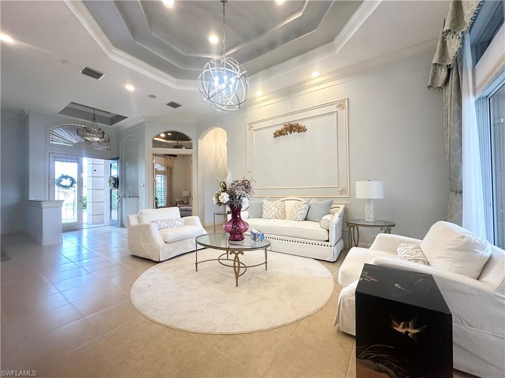 8411 Mallow Lane Naples, FL 34113 - Photo 2 of 31 a living room with furniture and a chandelier
