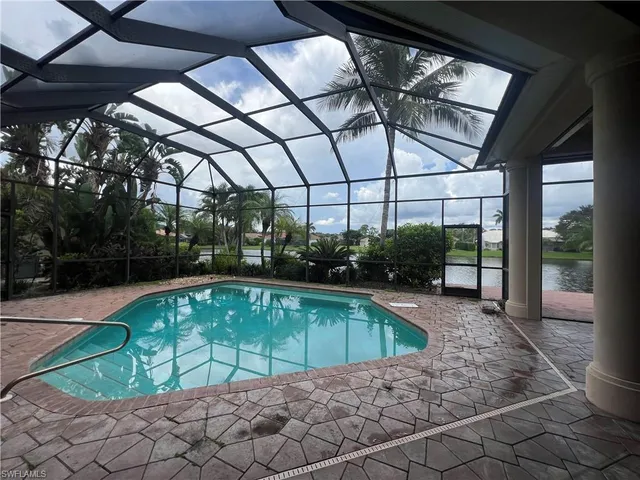 a view of a patio with table and chairs with wooden fence