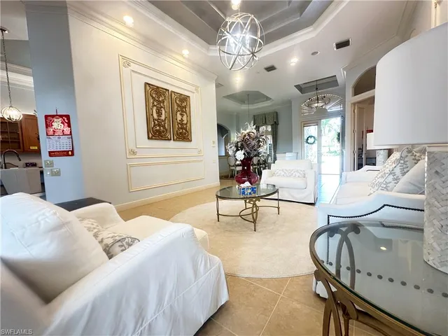 a bedroom with furniture and a chandelier