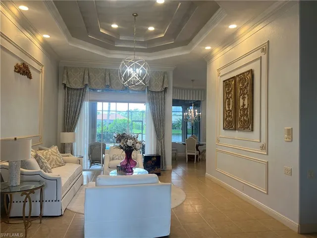 a living room with furniture and a chandelier