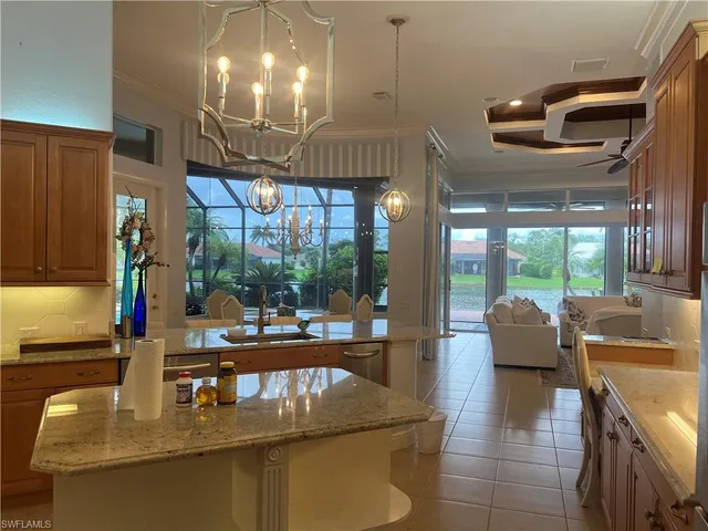 a dining room with furniture a chandelier and wooden floor