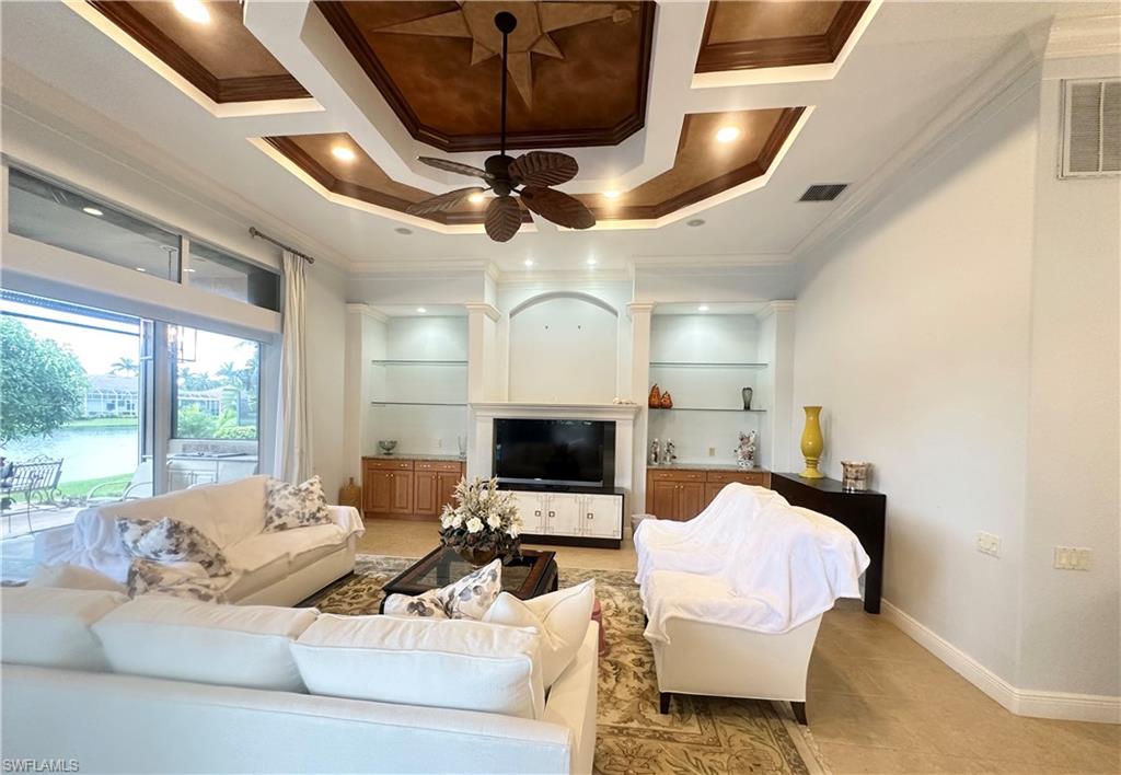 8411 Mallow Lane Naples, FL 34113 - Photo 10 of 31 a living room with furniture fireplace and a large window