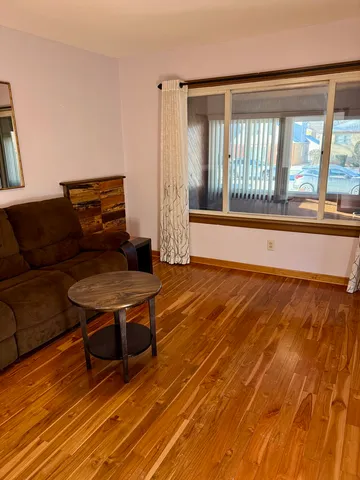 a living room with a furniture and a large window