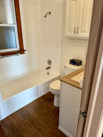 a bathroom with a toilet and a tub