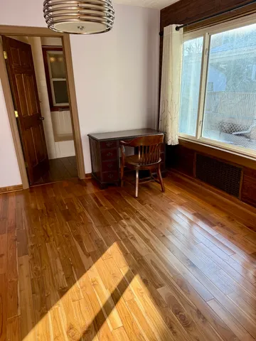 a room with wooden floor and furniture