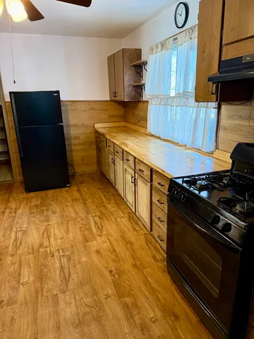 a kitchen with stainless steel appliances a stove a microwave and a refrigerator