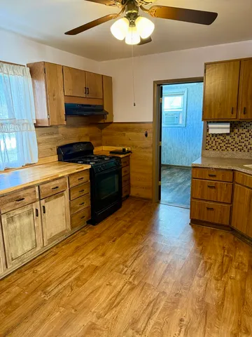 a kitchen with stainless steel appliances granite countertop a stove and a sink