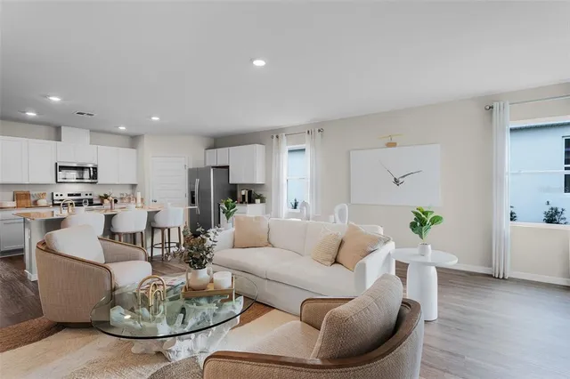 a living room with furniture kitchen and kitchen view