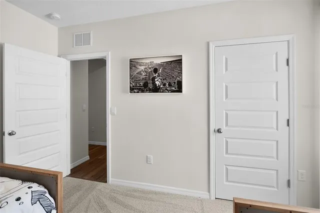 a bedroom with a bed and a closet