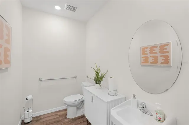 a bathroom with a toilet sink and mirror