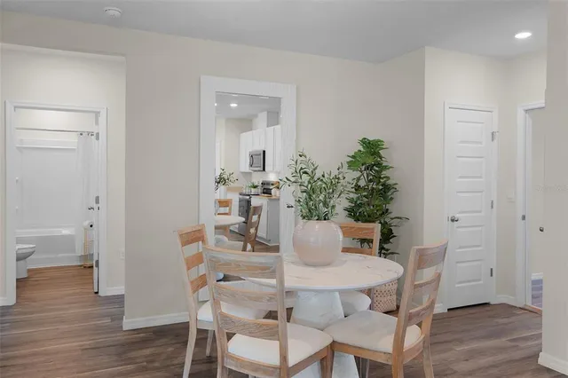 a view of a dining room with furniture and wooden floor