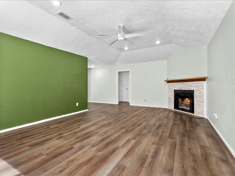 6631 Ambler Drive Spring, TX 77379 - Photo 11 of 37 wooden floor in an empty room with a fireplace