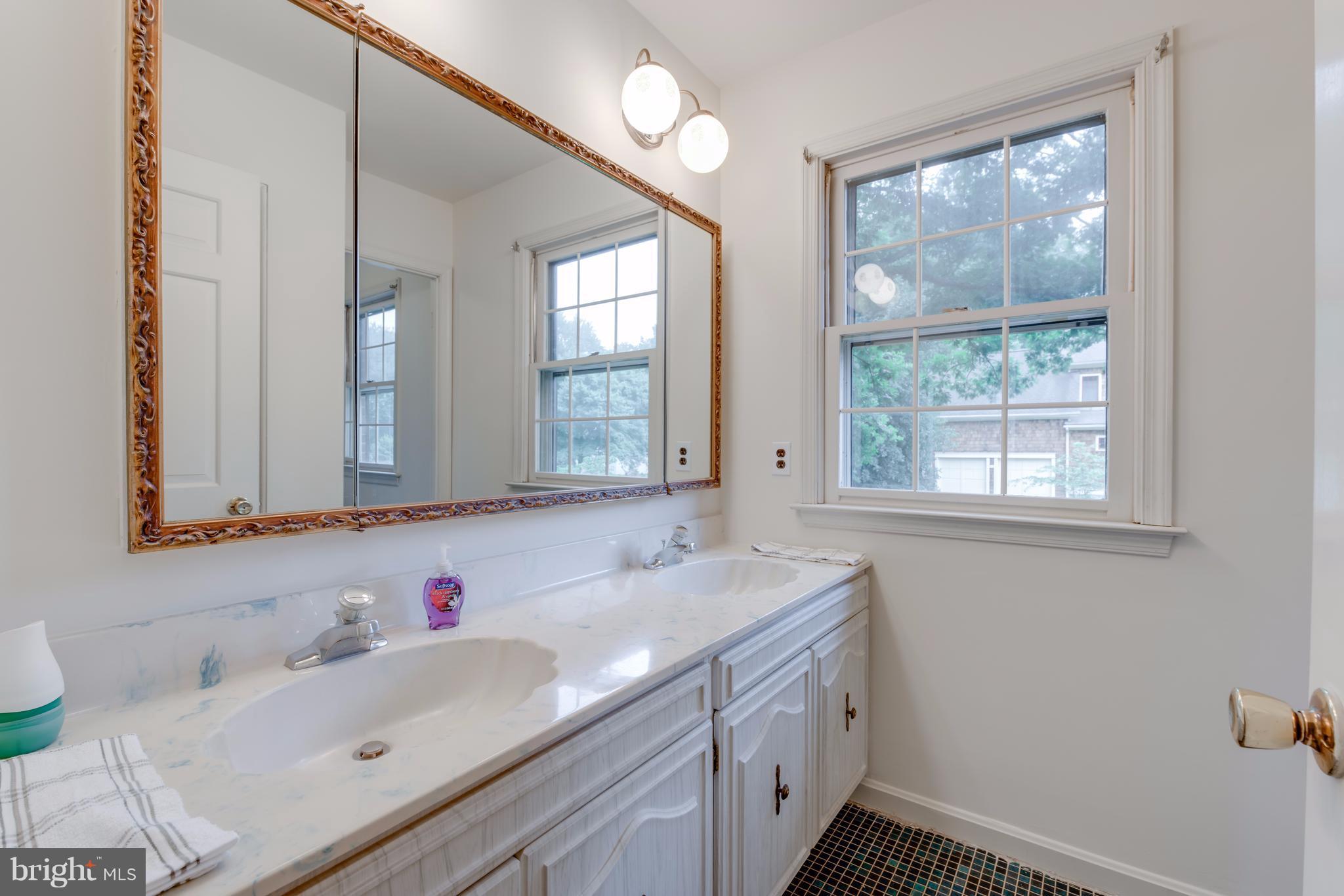 314 Ayito Road Southeast Vienna, VA 22180 - Photo 2 of 12 a bathroom with a sink and a window