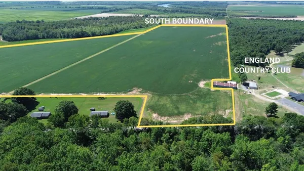 an aerial view of a residential houses with outdoor space and street view