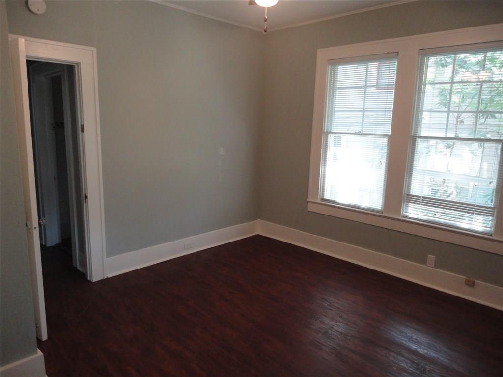200 East 33rd Street Austin, TX 78705 - Photo 23 of 27 an empty room with wooden floor and windows