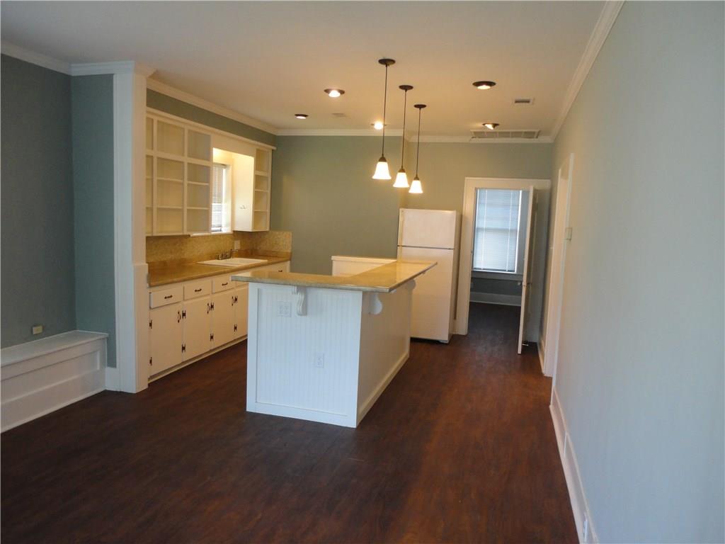 200 East 33rd Street Austin, TX 78705 - Photo 6 of 27 a view of a kitchen with a sink and dishwasher with wooden floor