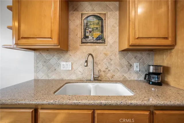 a kitchen with granite countertop a sink and cabinets